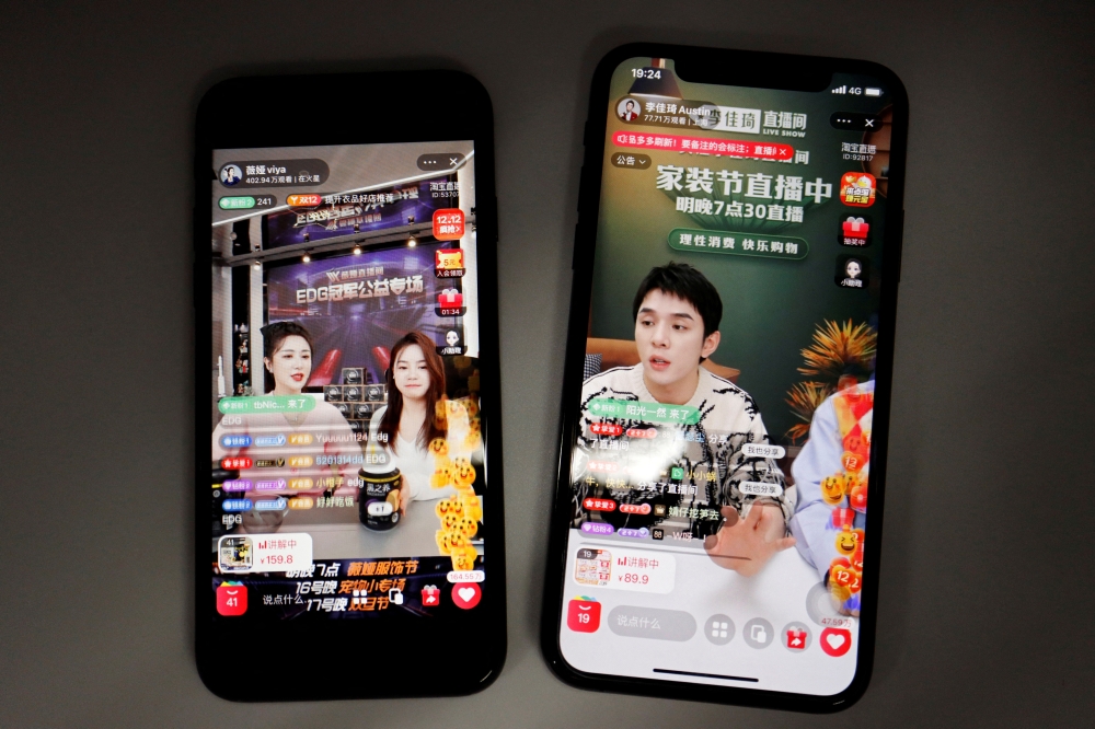 Livestreaming sessions by Chinese livestreamers Li Jiaqi and Viya, whose real name is Huang Wei, (L) are seen on Alibaba's e-commerce app Taobao displayed on mobile phones in this illustration picture taken December 14, 2021. REUTERS/Florence Lo/Illustration/File Photo