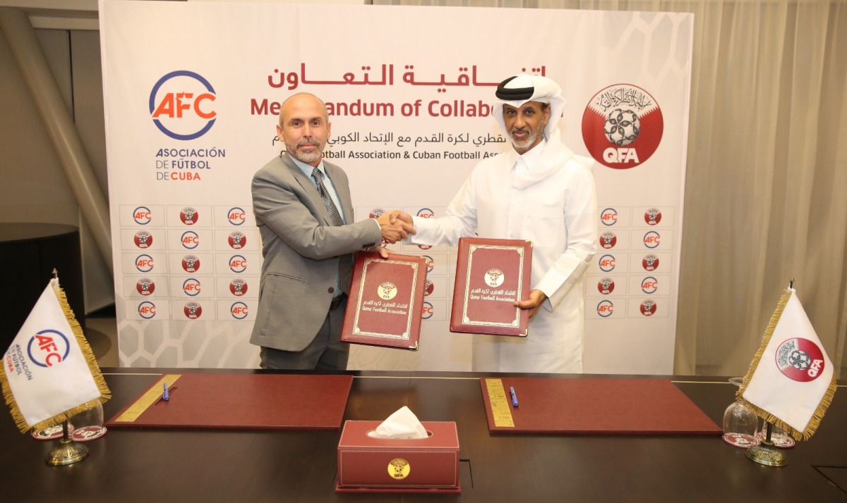 QFA President Sheikh Hamad bin Khalifa bin Ahmed Al Thani and President of the Cuban Football Association Oliet Rodriguez shake hands after the signing ceremony.
