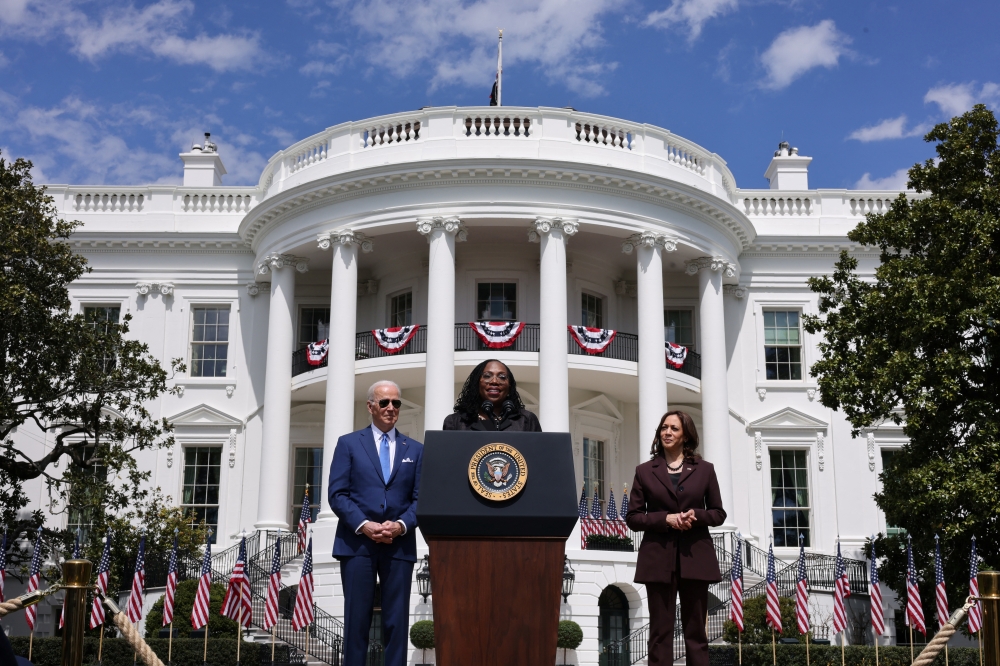 Judge Ketanji Brown Jackson delivers remarks while U.S. President Joe Biden and Vice President Kamala Harris listen as Jackson speaks about her confirmation as the first Black woman to serve on the U.S. Supreme Court, on the South Lawn at the White House in Washington, U.S., April 8, 2022. REUTERS/Kevin Lamarque