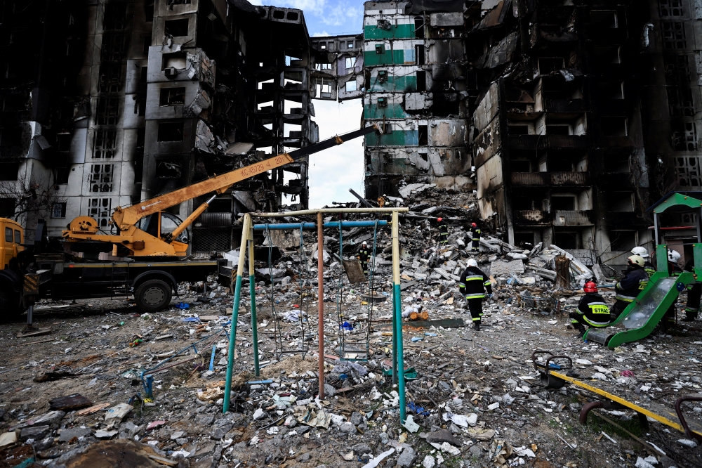 A rescuer walks during a search operation for bodies under the rubble of a building destroyed by Russian shelling, amid Russia's Invasion of Ukraine, in Borodyanka, Kyiv region, Ukraine April 11, 2022. REUTERS/Zohra Bensemra