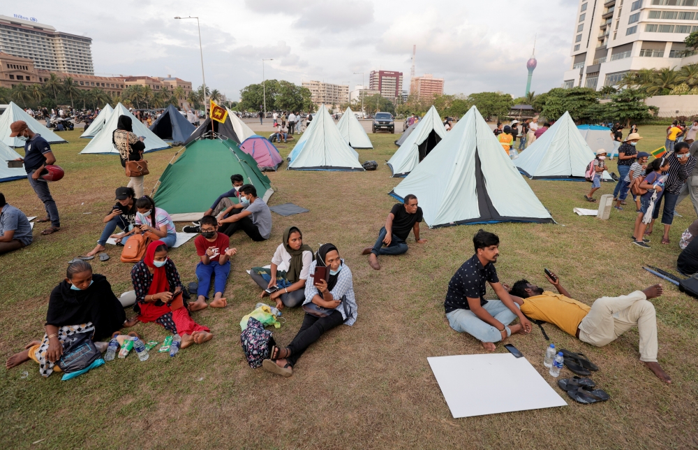 Demonstrators sit in a protest area, dubbed the Gota-Go village, near the Presidential Secretariat, in Colombo, Sri Lanka, April 11, 2022. Reuters/Dinuka Liyanawatte