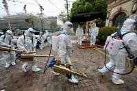 Volunteers in protective suits prepare to disinfect a residential compound in Huangpu district, to curb the spread of the coronavirus disease (COVID-19), in Shanghai, China. China Daily via REUTERS 