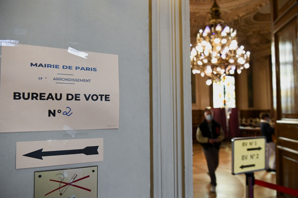 A sign is seen at a polling station in the second round of the 2022 French presidential election in Paris, France, April 24, 2022. Reuters/Piroschka Van De Wouw