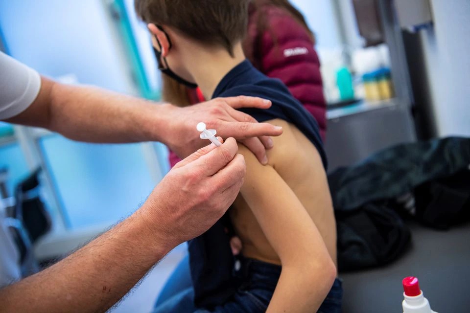 A boy gets children's dose of Comirnaty, the Pfizer-BioNTech vaccine against the coronavirus disease (COVID-19), at a vaccination centre in Ebersberg near Munich, Germany, December 15, 2021.REUTERS/Lukas Barth


