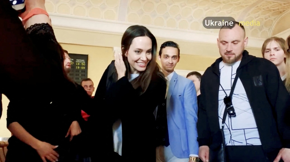 U.S. actor and UNHCR Special Envoy Angelina Jolie interacts with children at the main railway station during her visit to Lviv, amid Russia's ongoing invasion of Ukraine, in Lviv, Ukraine April 30, 2022 in this still image obtained from a social media video. Video recorded April 30, 2022. Lviv.Media via REUTERS