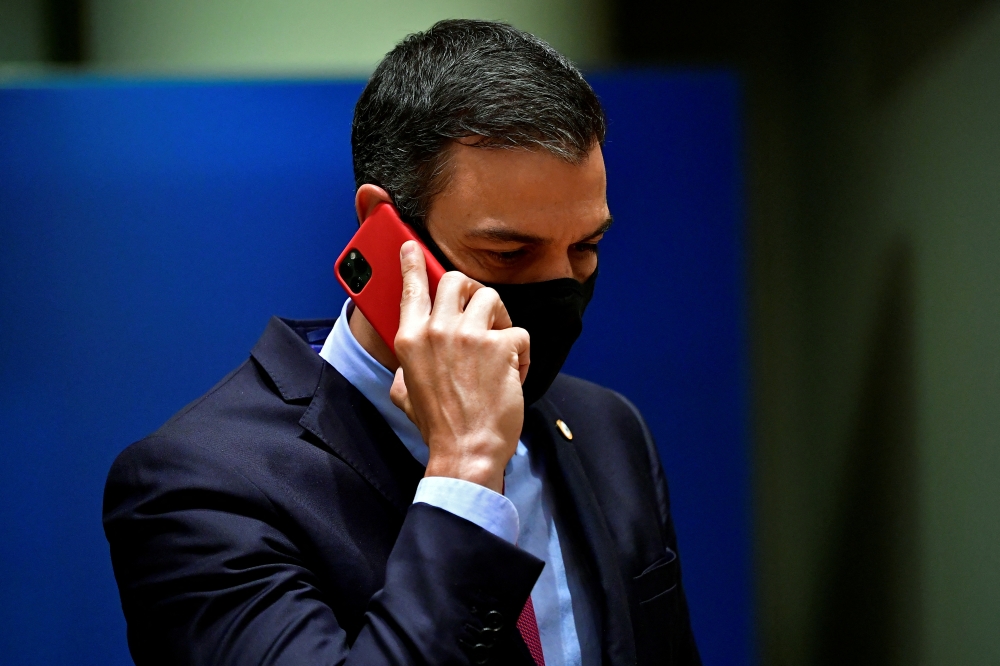 Spain's Prime Minister Pedro Sanchez talks on the phone during the first face-to-face EU summit since the coronavirus disease (COVID-19) outbreak, in Brussels, Belgium July 20, 2020. John Thys/Pool via Reuters/File Photo