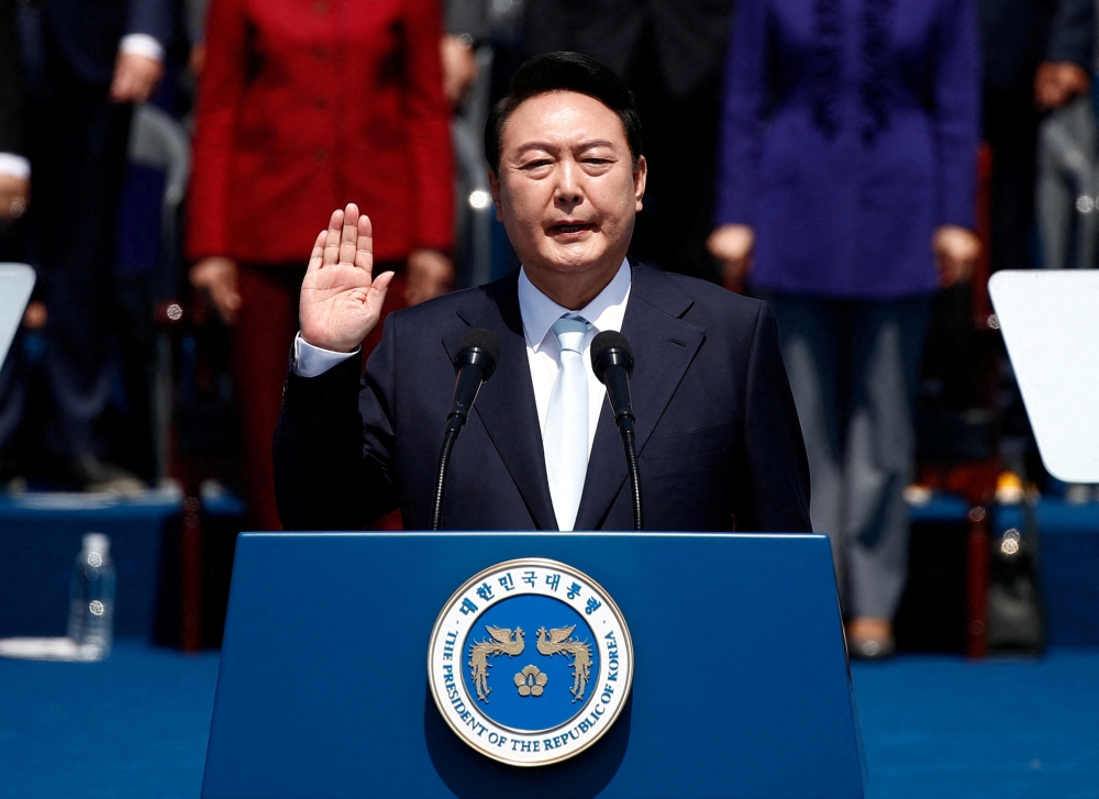 South Korean President Yoon Suk-yeol takes an oath during his inauguration in front of the National Assembly in Seoul, South Korea, May 10, 2022. Jeon Heon-Kyun /Pool via REUTERS