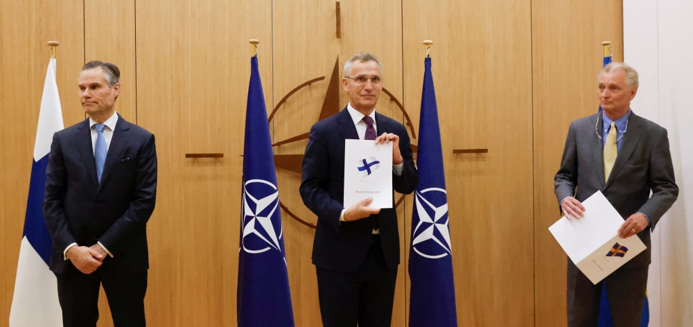 Finland's Ambassador to NATO Klaus Korhonen, NATO Secretary-General Jens Stoltenberg and Sweden's Ambassador to NATO Axel Wernhoff attend a ceremony to mark Sweden's and Finland's application for membership in Brussels, Belgium, May 18, 2022. Reuters/Johanna Geron/Pool