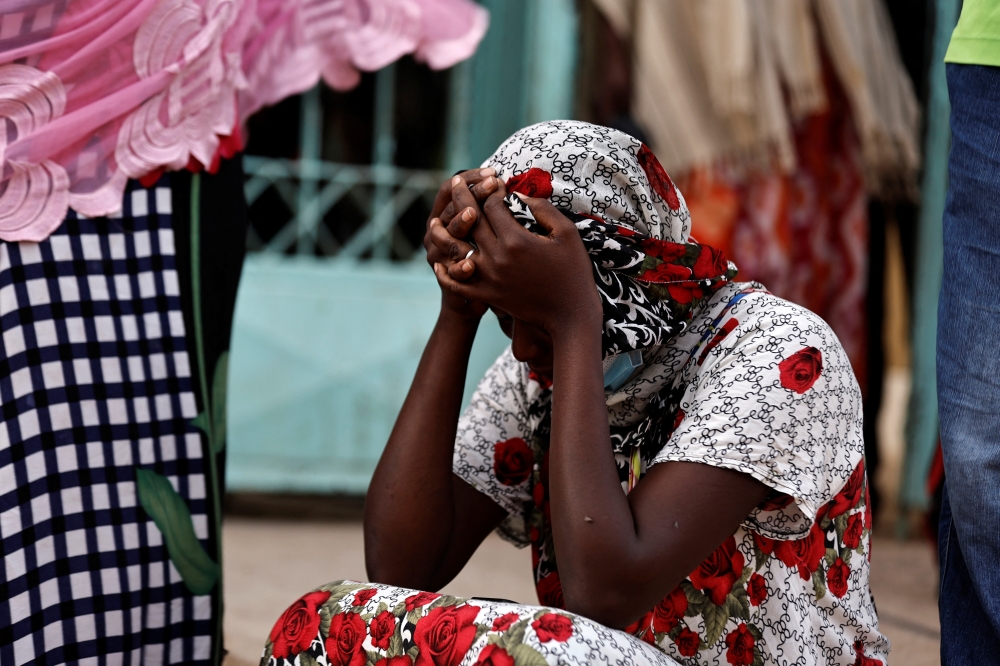 Kaba, a mother of a ten-day-old baby, reacts as she sits outside the hospital, where newborn babies died in a fire at the neonatal section of a regional hospital in Tivaouane, senegal, May 26, 2022. Reuters/Zohra Bensemra
