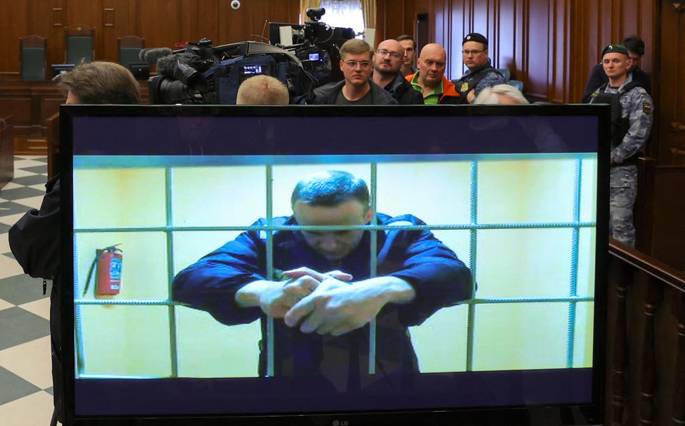 Jailed Russian opposition leader Alexei Navalny is seen on a screen during a court hearing in Moscow. Reuters
