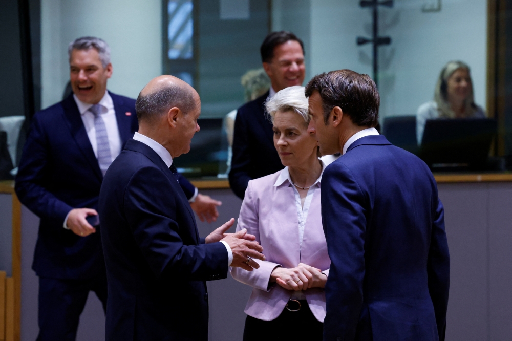 German Chancellor Olaf Scholz, European Commission President Ursula von der Leyen and French President Emmanuel Macron speak after arriving for Western Balkans countries meeting with EU leaders, in Brussels, Belgium June 23, 2022. Reuters/Yves Herman