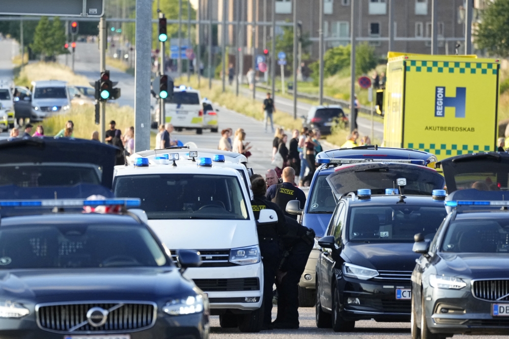 Police vehicles gather outside Fields shopping center, after Danish police said they received reports of a shooting at the site, in Copenhagen, Denmark, on July 3, 2022. (Reuters)