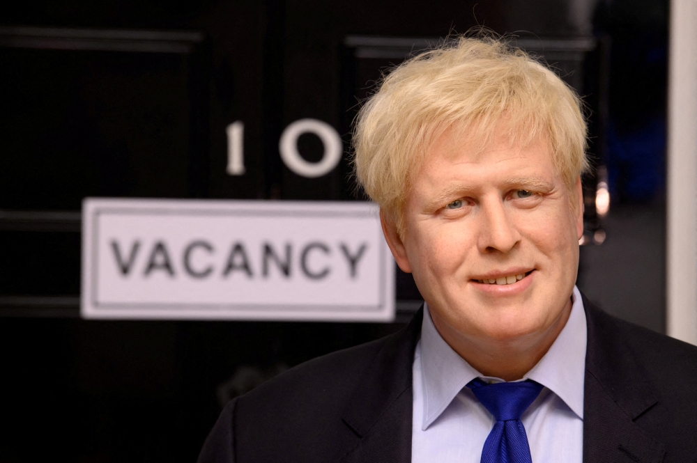 FILE PHOTO: A wax figure of Boris Johnson is pictured next to a 'vacancy' sign on 10 Downing Street at Madame Tussauds, in London, Britain July 7, 2022. Madame Tussauds London 
