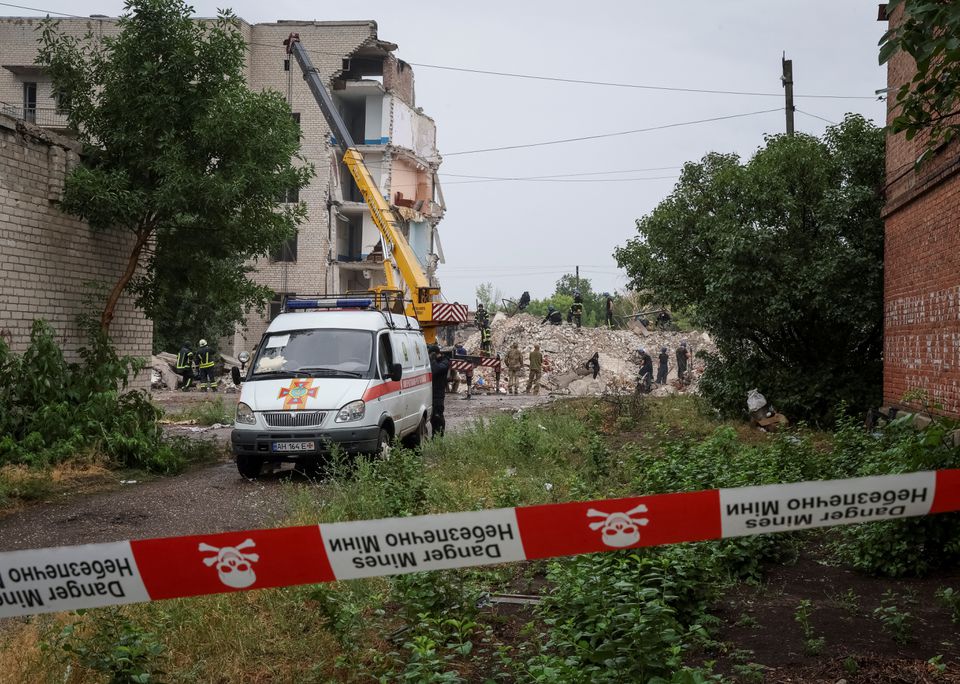 Rescuers work at a residential building damaged by a Russian military strike, amid Russia's invasion on Ukraine, in the town of Chasiv Yar, in Donetsk region, Ukraine, July 11, 2022. REUTERS/Gleb Garanich

