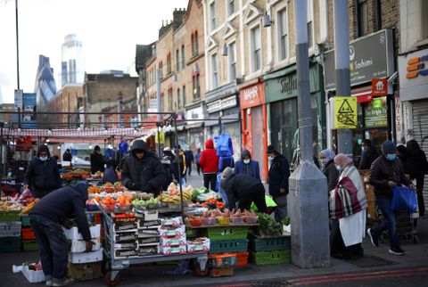 People shop at a market stalls in east London, Britain, January 23, 2021. REUTERS/Henry Nicholls