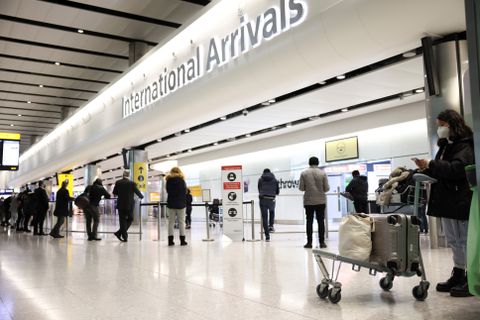 Travellers stand at Terminal 2 of Heathrow Airport, amid the coronavirus disease (COVID-19) outbreak in London, Britain February 14, 2021. REUTERS/Henry Nicholls/File Photo