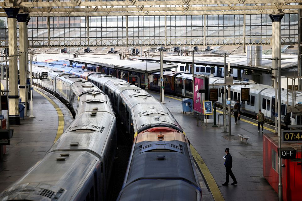 A view of trains on the platform at Waterloo Station as a station worker stands nearby, on the first day of national rail strike in London, Britain, June 21, 2022. REUTERS/Henry Nicholls


