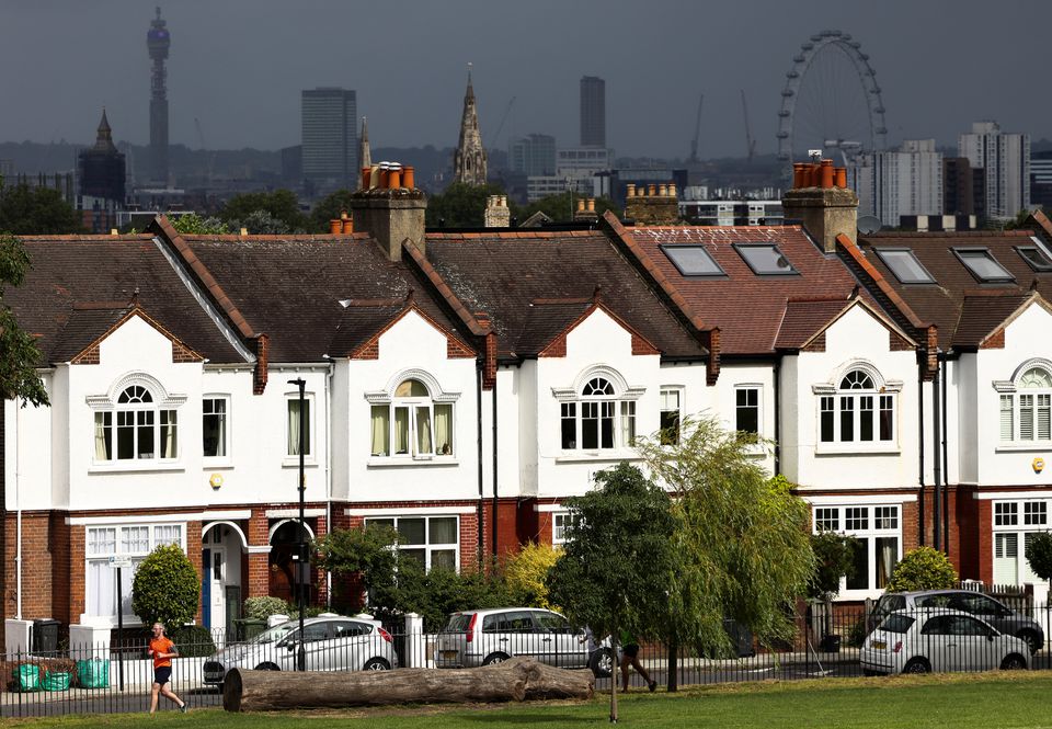 A person jogs past a row of residential housing in south London, Britain, August 6, 2021. REUTERS/Henry Nicholls

L