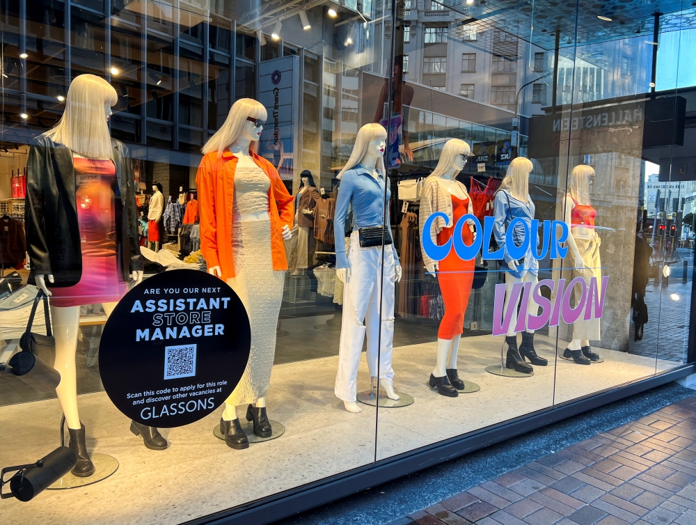 A sign advertising staff requirement is displayed on a store window at Lambton Quay, as the country experiences near record low unemployment, in Wellington, New Zealand August 3, 2022. Reuters/Lucy Craymer