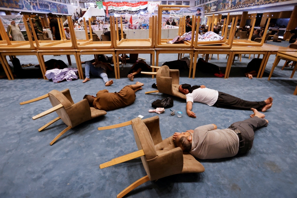 Supporters of Iraqi populist leader Moqtada al-Sadr sleep during a sit-in at the parliament building, amid political crisis in Baghdad, Iraq, August 3, 2022.(REUTERS/Ahmed Saad)