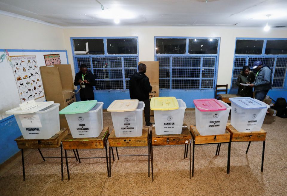 Workers from the Independent Electoral and Boundaries Commission (IEBC) prepare a polling centre ahead of the opening of the general election in Nairobi, Kenya August 9, 2022. REUTERS/Thomas Mukoya


