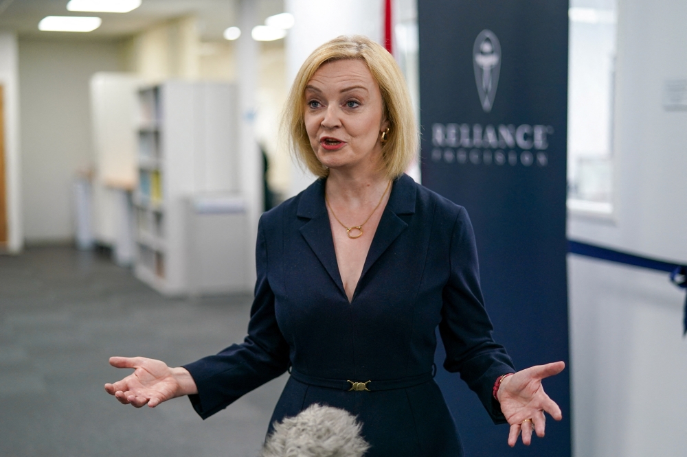 Britain's Conservative Party leadership candidate Liz Truss speaks to the media as she visits the Reliance Precision engineering company ahead of a hustings event later, in Huddersfield, Britain August 9, 2022. Ian Forsyth/Pool via REUTERS