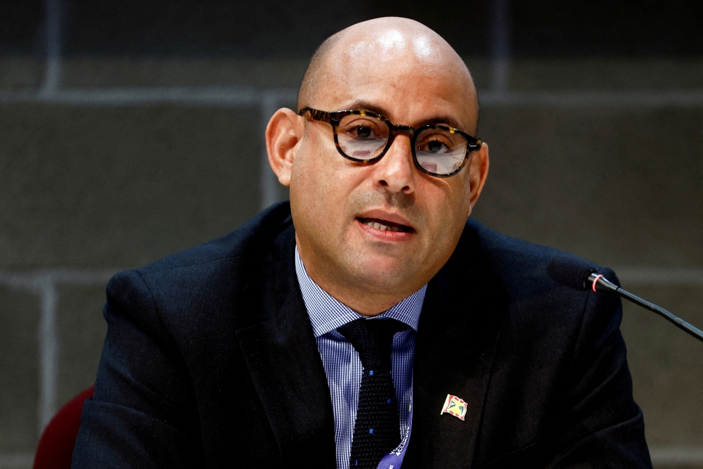 File Photo: Simon Stiell speaks at a news conference during the pre-COP26 climate meeting in Milan, Italy, on October 2, 2021. (REUTERS/Guglielmo Mangiapane)
