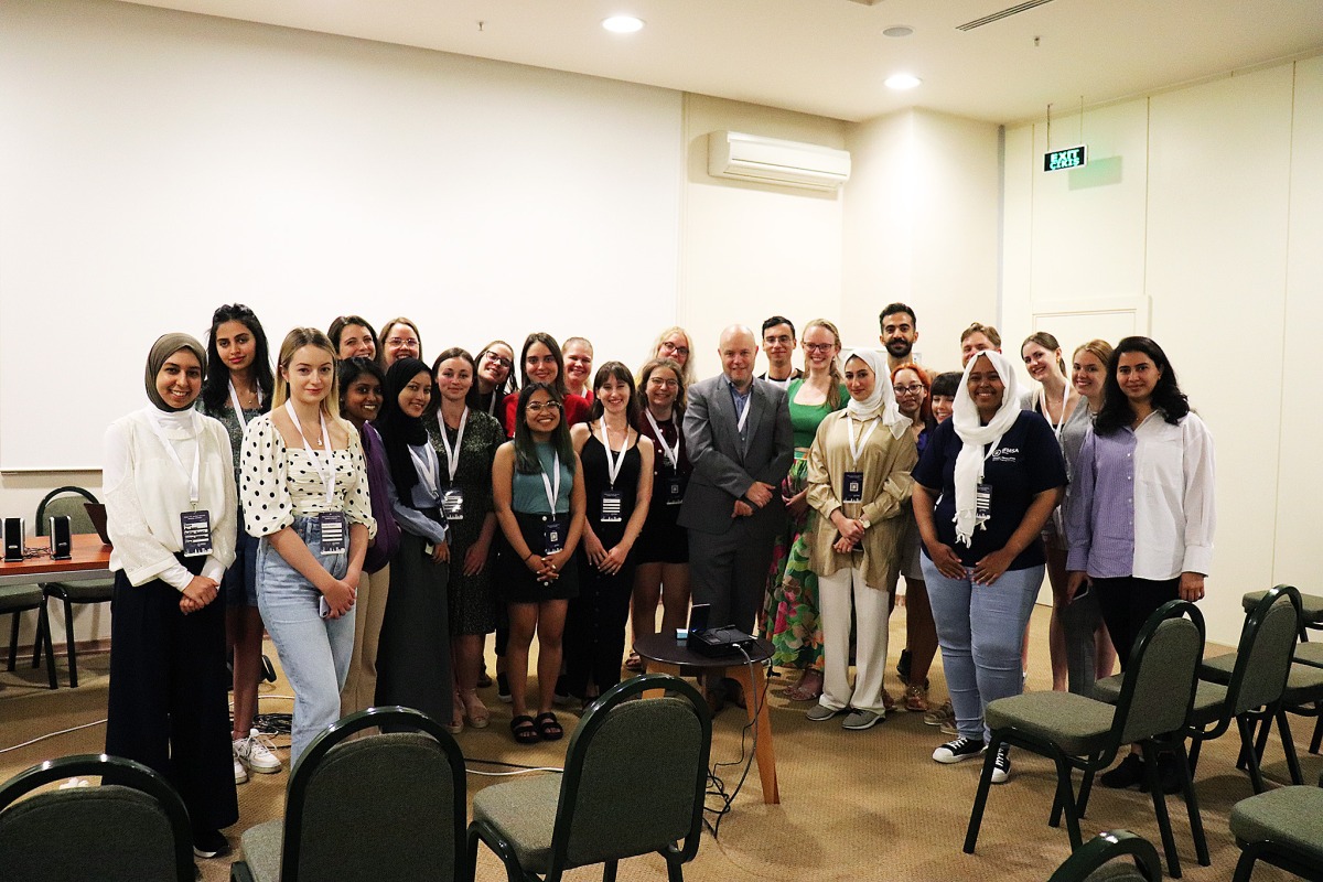 Nick Bradshaw, World Innovation Summit for Health’s (WISH) Director of Partnerships and Outreach (centre), with participating students at the meet.