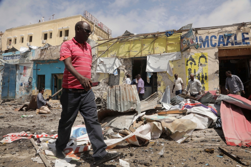Residents look at the scene of an al Qaeda-linked al Shabaab group militant attack, in Mogadishu, Somalia August 21, 2022. Reuters/Feisal Omar