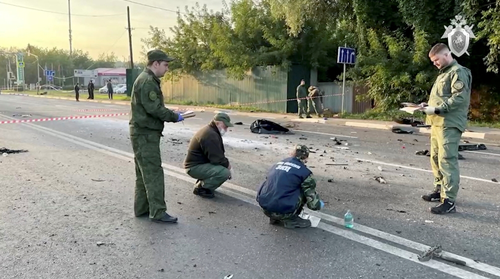 Reuters image of investigators at the site of suspected car bomb attack that killed Darya Dugina