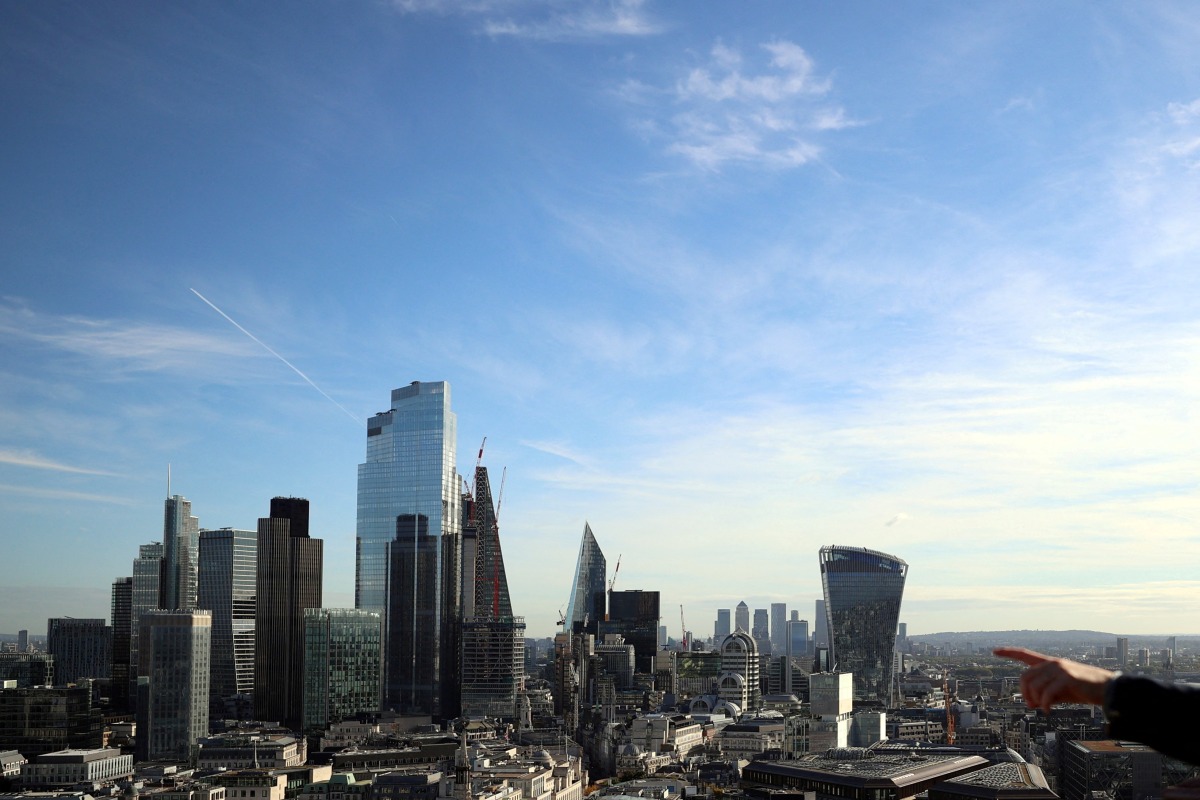 A person points to the City of London financial district from a viewing platform in London, Britain, on October 22, 2021. File Photo/ Reuters
