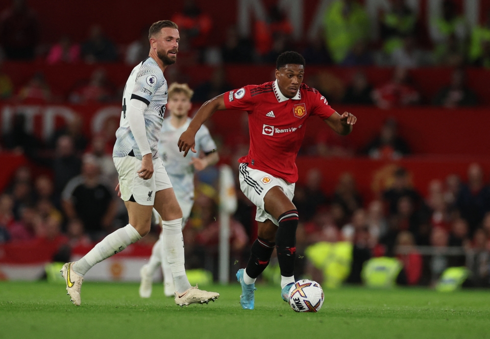 Liverpool's Jordan Henderson in action with Manchester United's Anthony Martial REUTERS/Phil Noble 