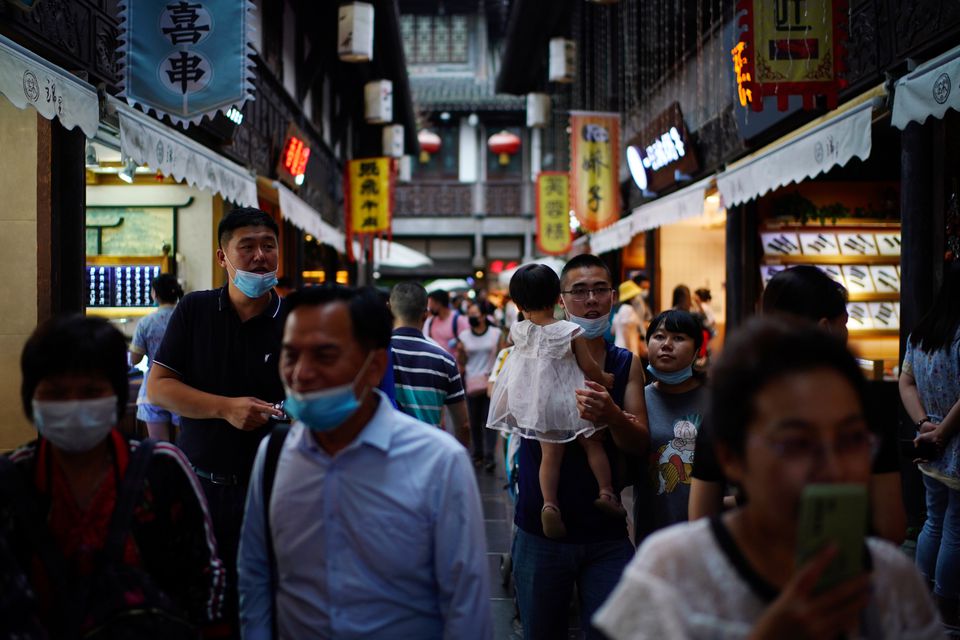People wearing face masks walk on Jinli Ancient Street, following the coronavirus disease (COVID-19) outbreak, in Chengdu, Sichuan province, China September 8, 2020. REUTERS/Tingshu Wang

