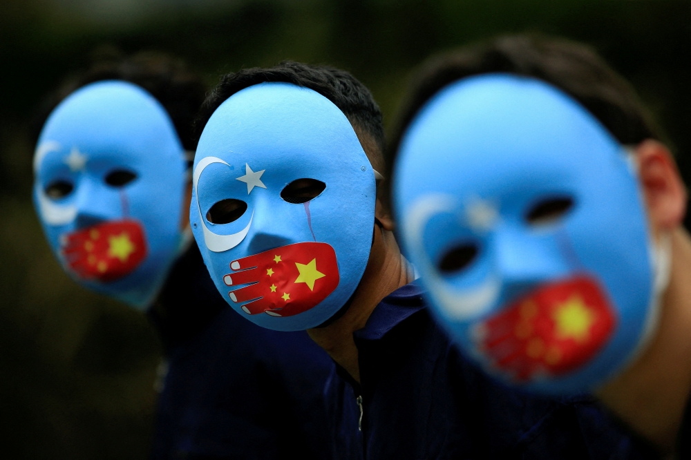 Activists take part in a protest against China's treatment towards the ethnic Uyghur people and calling for a boycott of the 2022 Winter Olympics in Beijing, at a park Jakarta, Indonesia, January 4, 2022. (REUTERS/Willy Kurniawan)