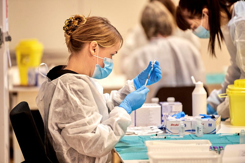 Pfizer-BioNTech COVID-19 vaccine is prepared for Plejecenter Faelledgaarden nursing home residents to get their second shot in Copenhagen, Denmark January 23, 2021. Ritzau Scanpix/Nils Meilvang via REUTERS/Files

