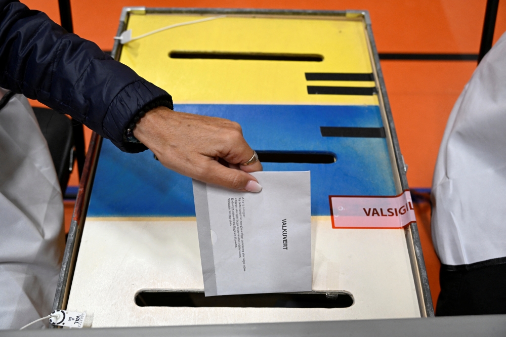 A person casts a ballot at a polling station in Stockholm, Sweden, September 11, 2022. Pontus Lundahl/TT News Agency/via Reuters