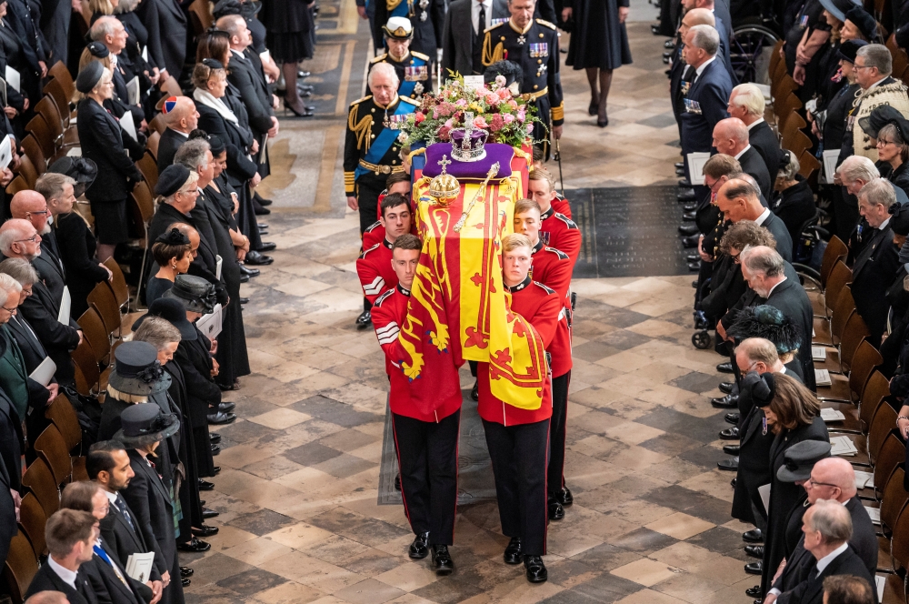 King Charles III, the Queen Consort, the Princess Royal, Vice Admiral Sir Tim Laurence, the Duke of York, the Earl of Wessex, the Countess of Wessex, the Prince of Wales, the Princess of Wales, Prince George, Princess Charlotte, the Duke of Sussex, the Duchess of Sussex, Peter Phillips and the Earl of Snowdon follow behind the coffin of Queen Elizabeth II, draped in the Royal Standard with the Imperial State Crown and the Sovereign's orb and sceptre, as it is carried out of Westminster Abbey after her State Funeral on September 19, 2022. Danny Lawson/Pool via REUTERS