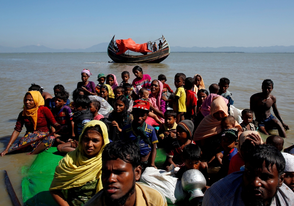 File Photo: Rohingya refugees sit on a makeshift boat as they get interrogated by the Border Guard Bangladesh after crossing the Bangladesh-Myanmar border, at Shah Porir Dwip near Cox's Bazar, Bangladesh, on November 9, 2017. (REUTERS/Navesh Chitrakar)