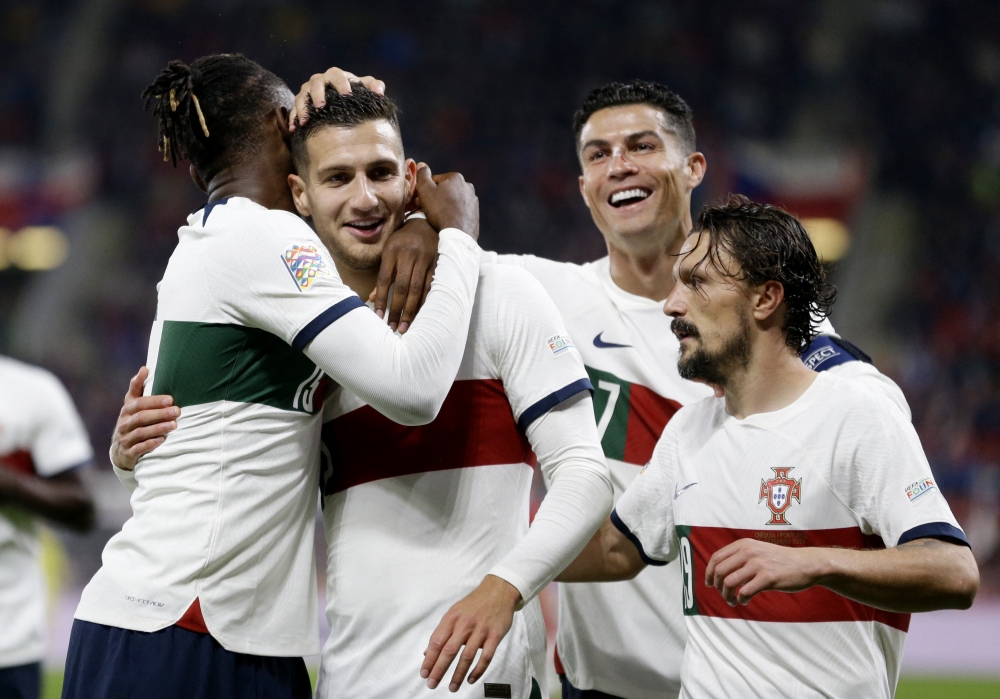 Portugal's Diogo Dalot celebrates scoring their third goal with Rafael Leao, Cristiano Ronaldo and Mario Rui during the UEFA Nations League Group B match against Czech Republic at the Eden Arena, Prague, Czech Republic, on September 24, 2022.  REUTERS/David W Cerny