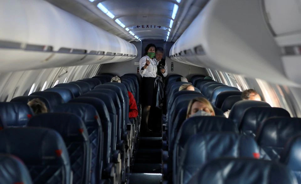 Flight attendants talk in a nearly empty cabin on a Delta Airlines flight operated by SkyWest Airlines during a flight departing from Salt Lake City, Utah, US on April 11, 2020. File Photo / Reuters
