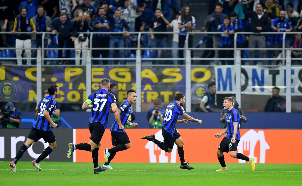 Inter Milan's Hakan Calhanoglu celebrates scoring their first goal with Lautaro Martinez and Nicolo Barella REUTERS/Daniele Mascolo
