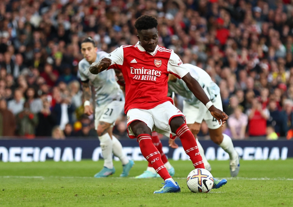 Arsenal's Bukayo Saka scores their third goal from the penalty spot during the EPL match against Liverpool at the Emirates Stadium in London on October 9, 2022.   REUTERS/David Klein