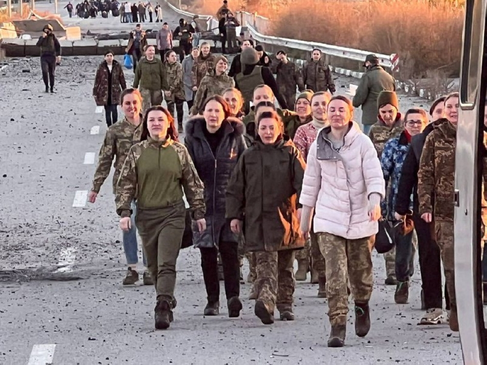 Ukrainian prisoners of war (POWs) walk after a swap, amid Russia's attack on Ukraine, in an unknown location, Ukraine, on October 17, 2022. Head of Ukraine's Presidential Office Andriy Yermak via Telegram/Handout via REUTERS