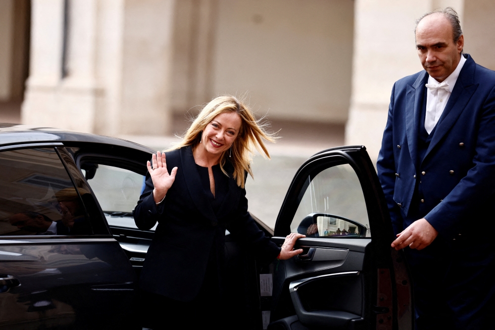 Italy's new Prime Minister Giorgia Meloni waves as she leaves Quirinale Presidential Palace on the day of the swearing-in ceremony, in Rome, Italy October 22, 2022. REUTERS/Yara Nardi