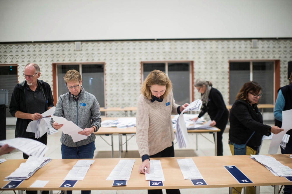 Members of the local electoral commission count votes at the polling station at Odense Town Hall, Denmark, on November 1, 2022. Ritzau Scanpix via REUTERS