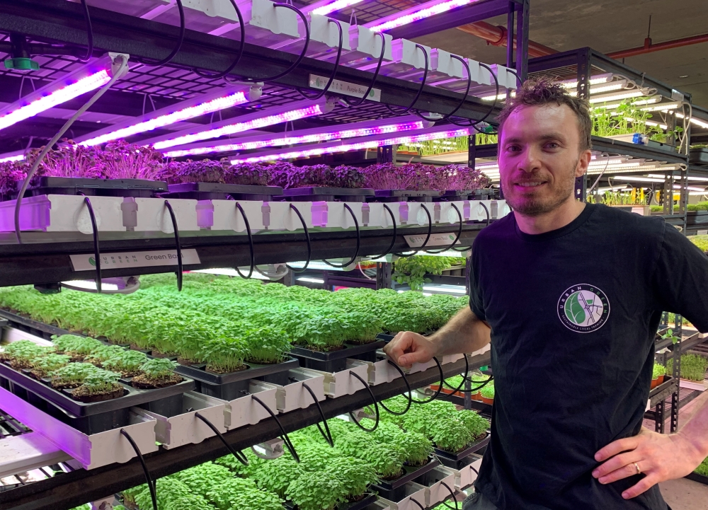Noah Verin, the owner of Sydney farm Urban Green, stands near herbs and micro-greens that he grows with his team in a basement carpark at central business district, in Sydney, Australia, October 27, 2022. REUTERS/Stefica Nicol Bikes