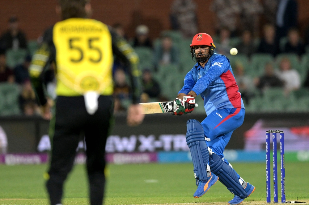 Afghanistan's Captain Mohammad Nabi plays a shot in the air and is out during the ICC men's Twenty20 World Cup 2022 cricket match between Australia and Afghanistan at Adelaide Oval on November 4, 2022 in Adelaide. (AFP/Brenton EDWARDS)