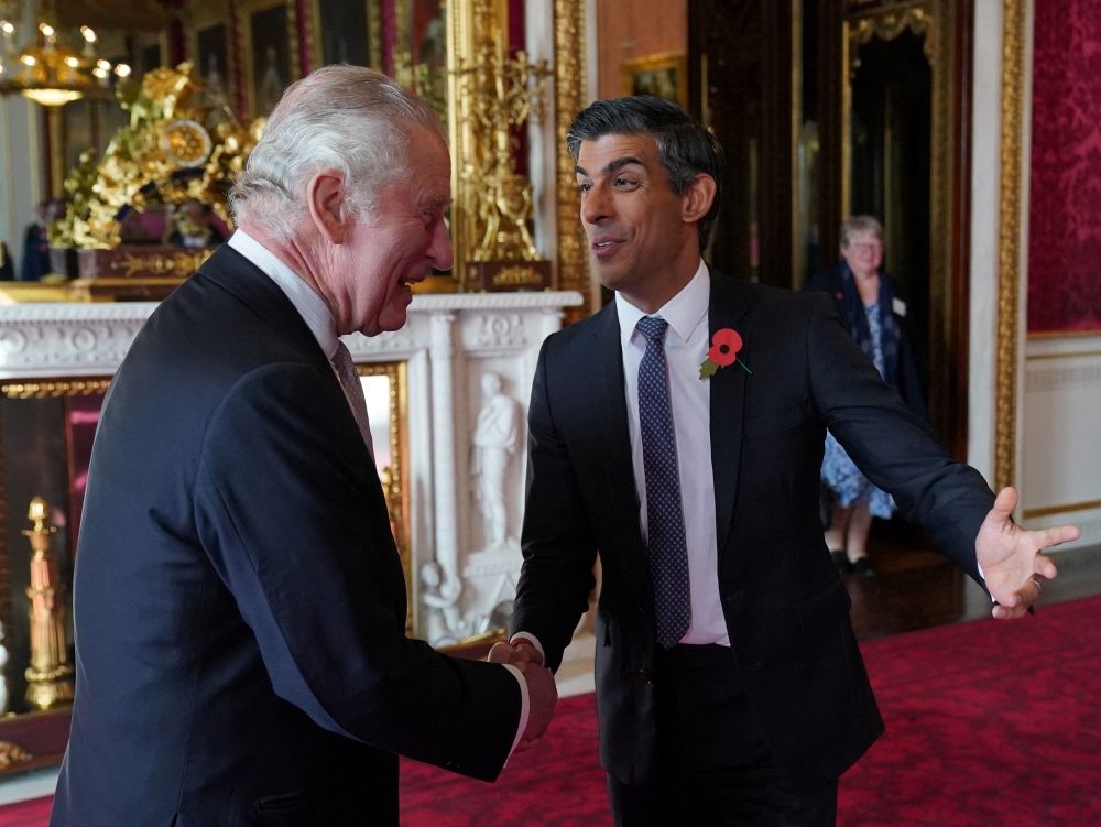 King Charles III greets Prime Minister Rishi Sunak, during a reception at Buckingham Palace, London, ahead of the Cop27 Summit, November 4, 2022. (Jonathan Brady/Pool via REUTERS)