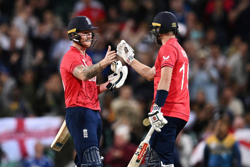 England's Chris Woakes and Ben Stokes celebrate after winning the match Dan Himbrechts/AAP Image via Reuters
