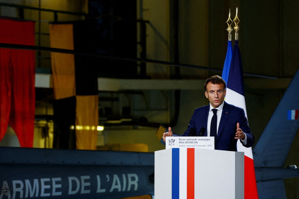 France's President Emmanuel Macron delivers a speech on defence strategy to present the La Revue nationale strategique (RNS), a new military programming law (2024-2030), on the amphibious helicopter carrier Dixmude docked in the French Navy base of Toulon, Southern France on November 9, 2022. (AFP/Eric Gaillard)